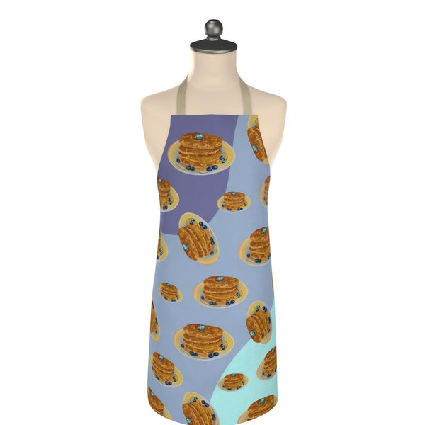 Stacks on stacks Apron with pattern of falling syrup covered flapjacks on a navy blue, periwinkle and teal background 