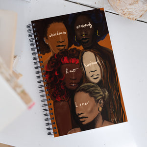 Manifestation journal is Spiral bound  with the five beautiful faces in varying shades of melanin