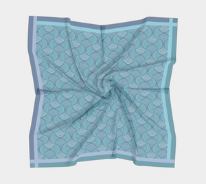 Silk charmeuse scarf with blue and teal geometric pattern slightly scrunched up 